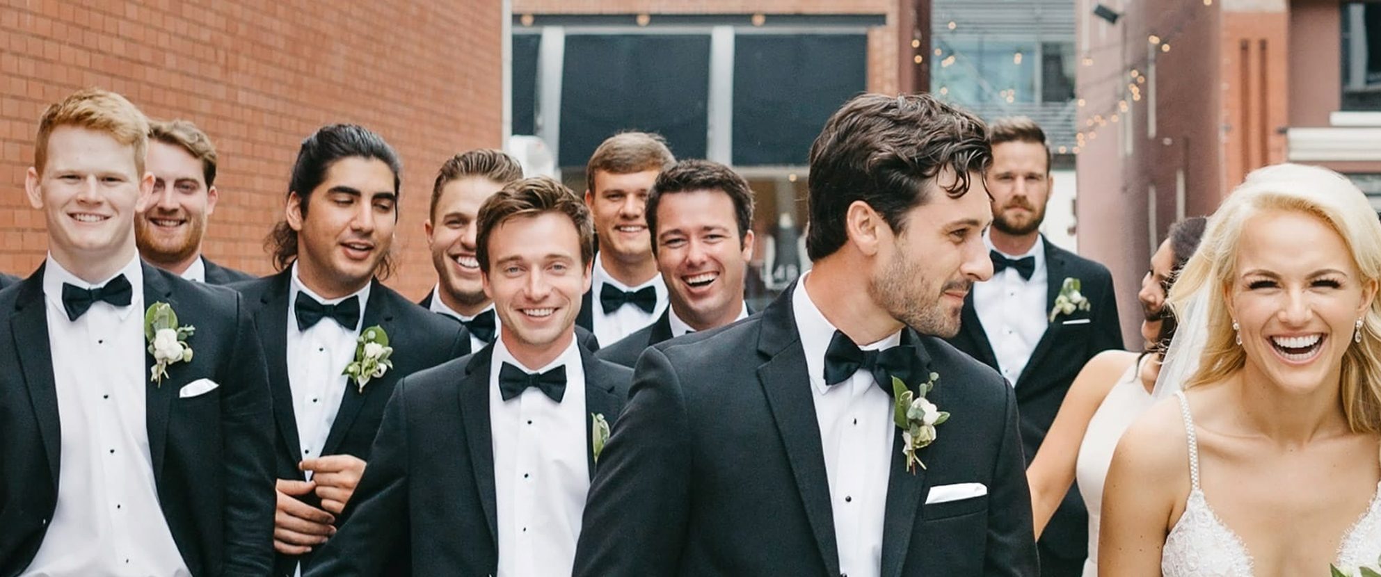 Edward's Men's Wear Formal Wear: Wedding scene, bride and groom with groomsmen.